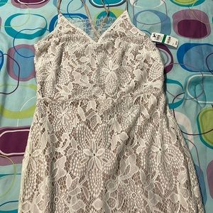 Brand NEW tan sparkly dress with a white lace overlay.